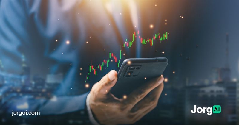 Hand holding a phone with a stock chart against a city skyline at night, cover for the September 2026 retail sales preview