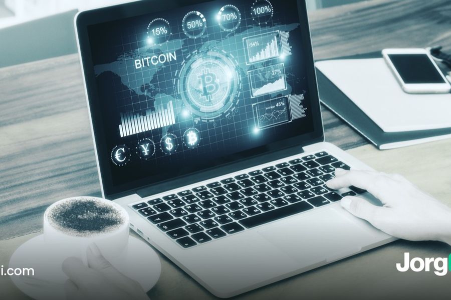 Laptop showing a Bitcoin trading dashboard on a desk, illustrating grid, DCA and rules-based bots on Kraken