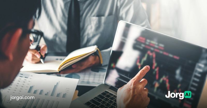 Two analysts reviewing printed charts and a laptop price chart ahead of the September 2026 ISM Services PMI report