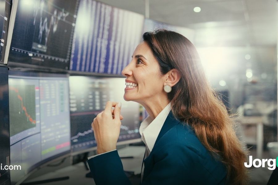 Trader smiling at a wall of stock charts, illustrating the Q3 2026 earnings season