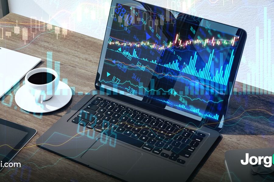 Laptop and tablet showing stock charts on a desk, cover for the broker API options automation comparison