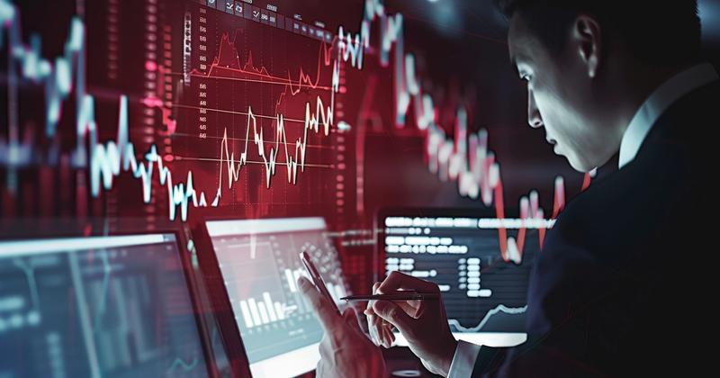 Trader watching a declining red stock chart during a weak September market