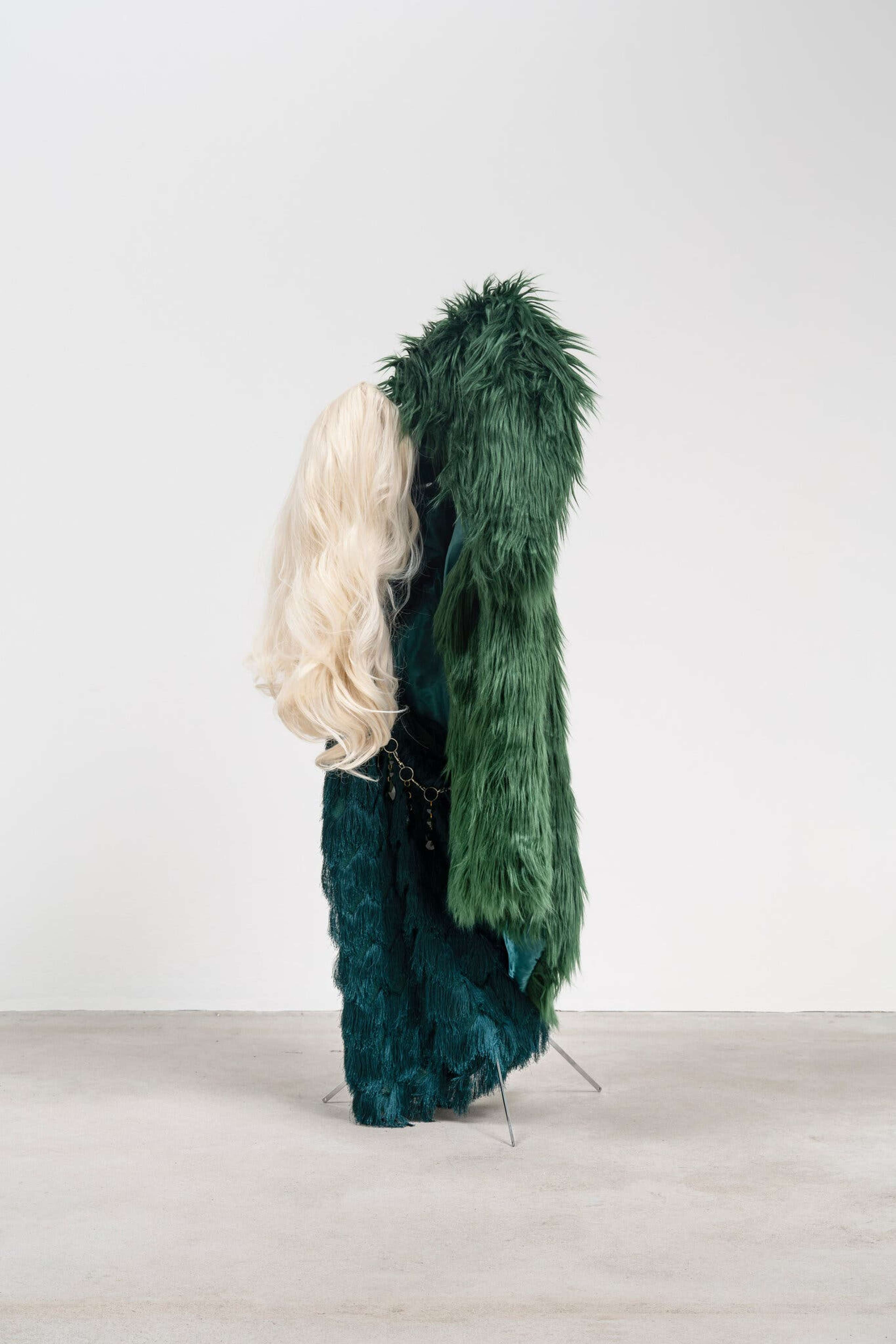 Kayode Ojo’s “Overdressed (Emerald),” from 2022, includes materials like heat-resistant synthetic wigs and faux fur.