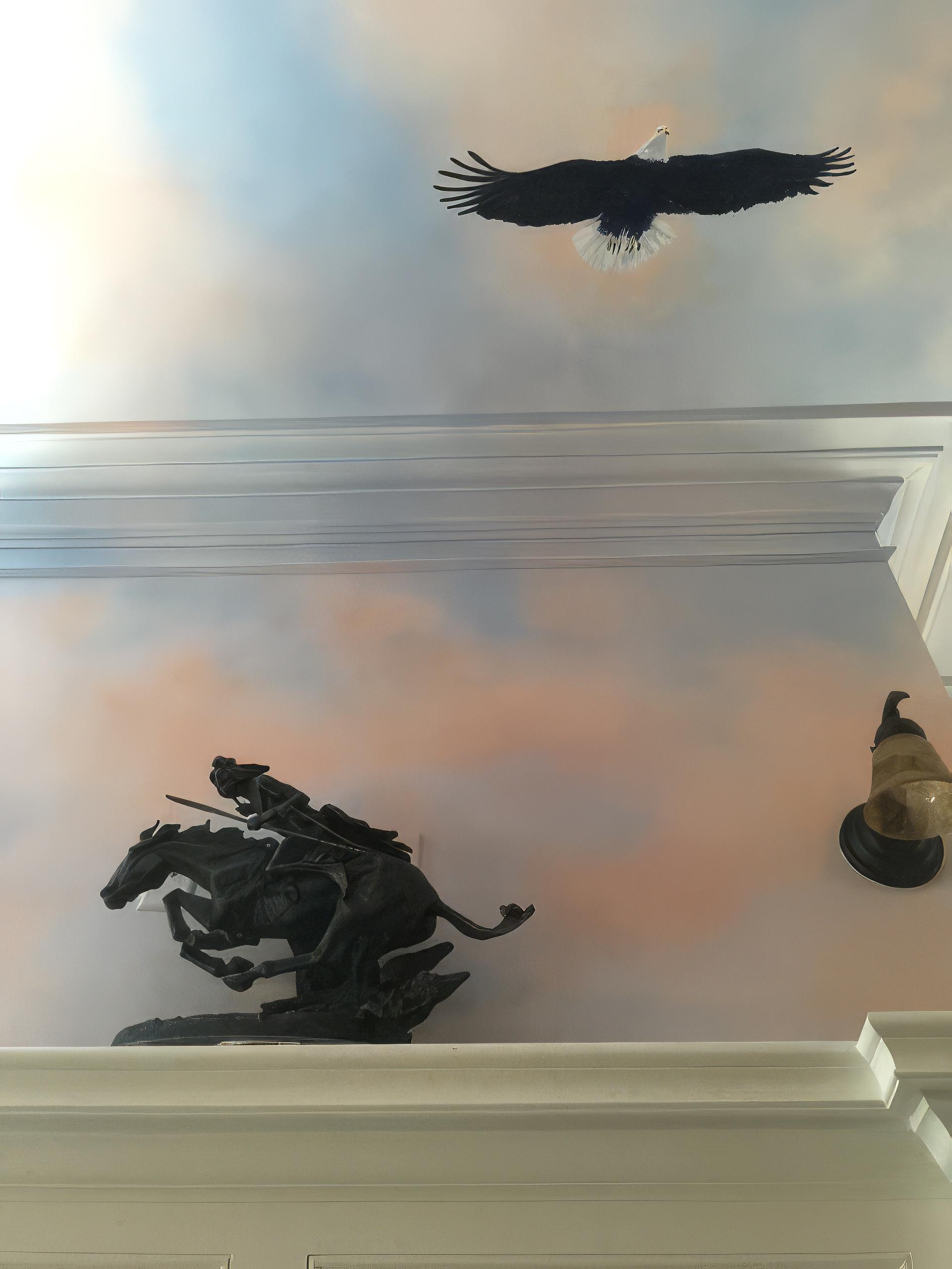 Hand-painted ceiling mural with trompe l'oeil bald eagle and sunset sky in Early American themed law firm