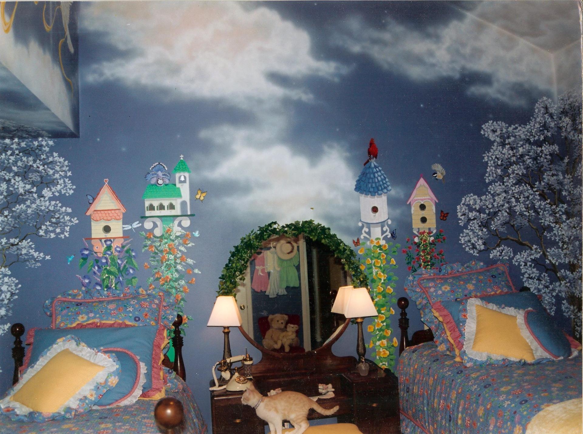 Whimsical hand-painted full-room mural in twin bedroom with night sky, trompe l'oeil birdhouses, flowering vines, and blossom