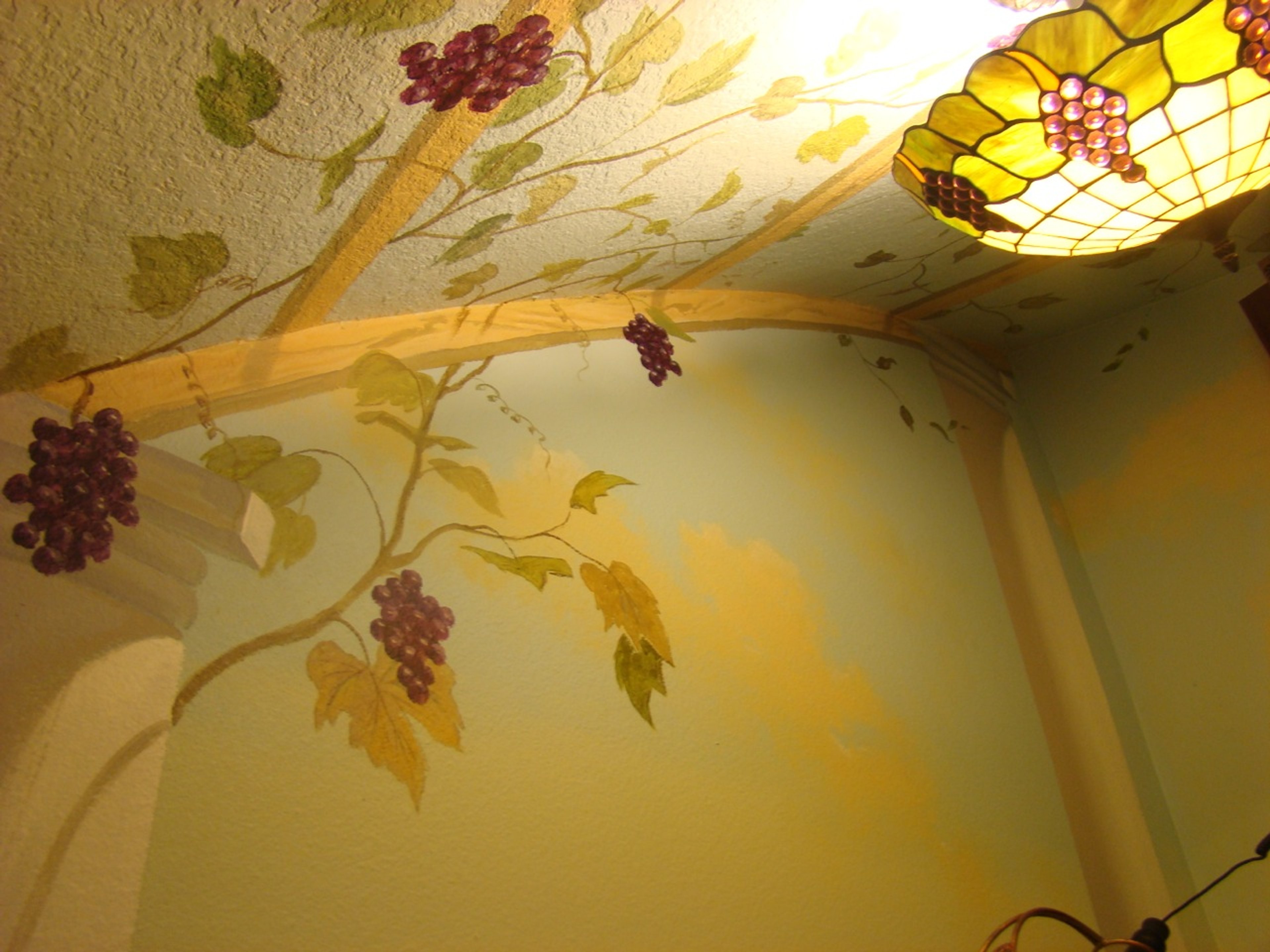 Hand-painted Italian vineyard grapevine mural with trompe l'oeil pergola spanning wall and ceiling, Houston TX