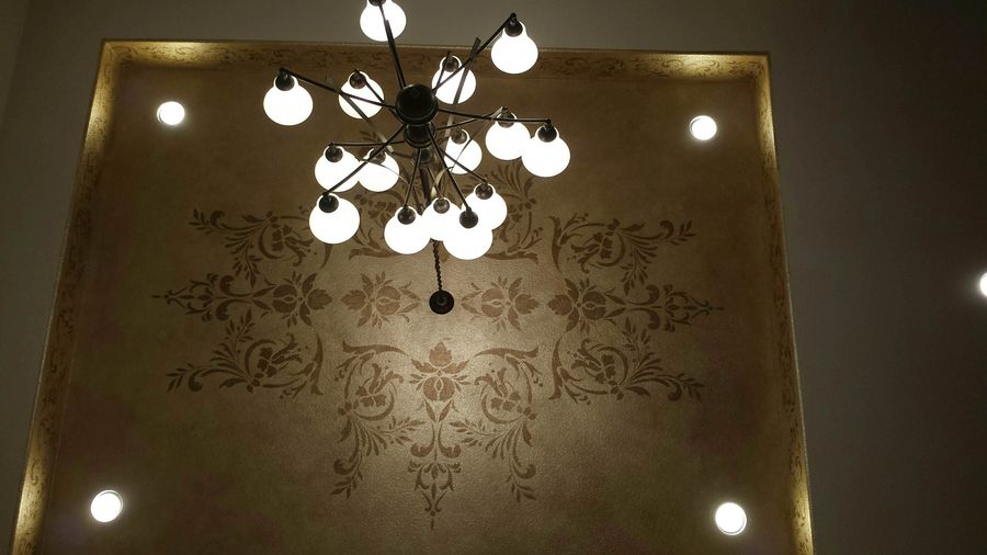 Metallic glazed tray ceiling with bronze acanthus stencil medallion and Sputnik chandelier in luxury foyer
