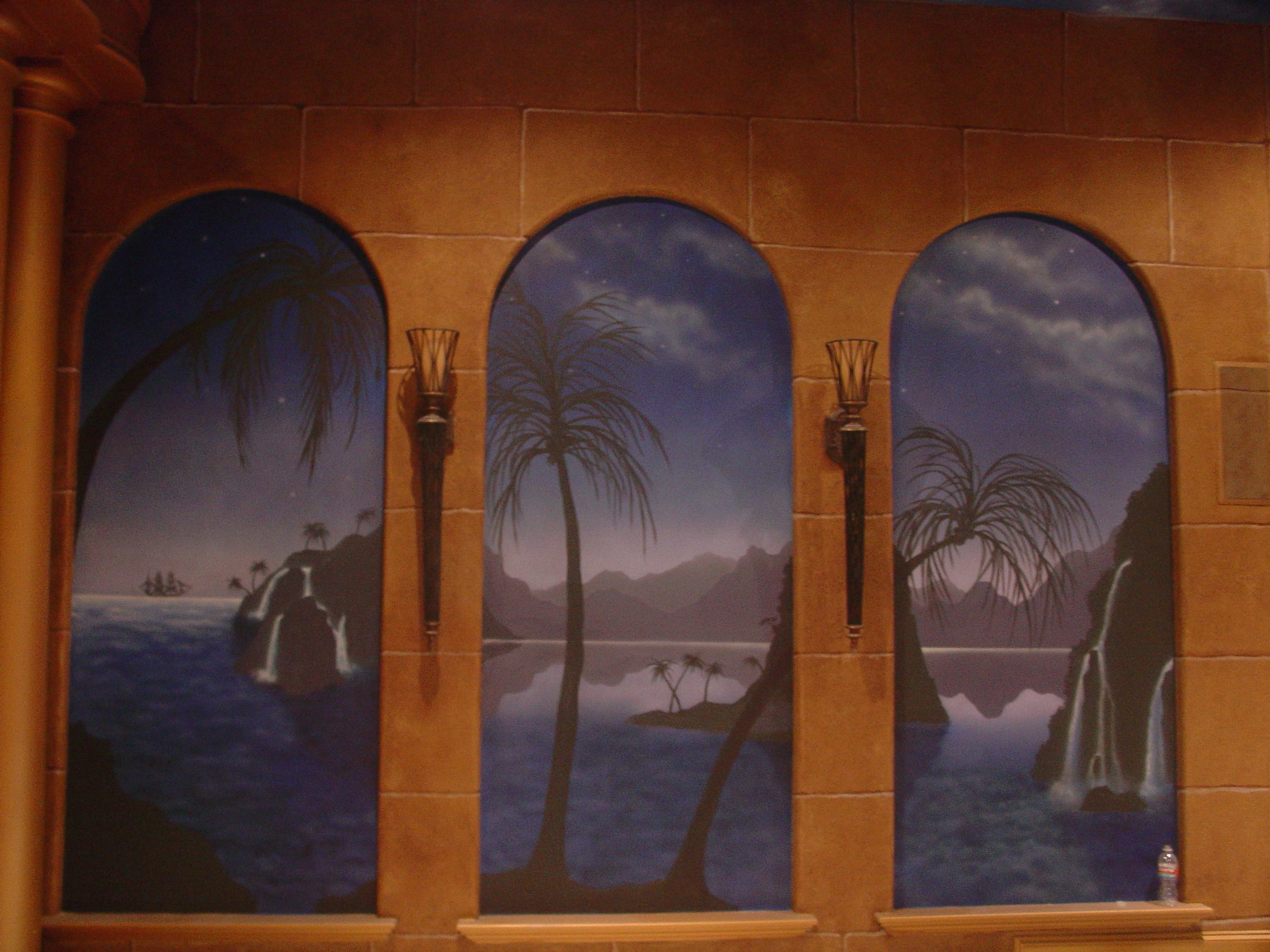 Triptych tropical night scene trompe l'oeil mural with faux stone arched windows, palm silhouettes and waterfalls, Houston TX