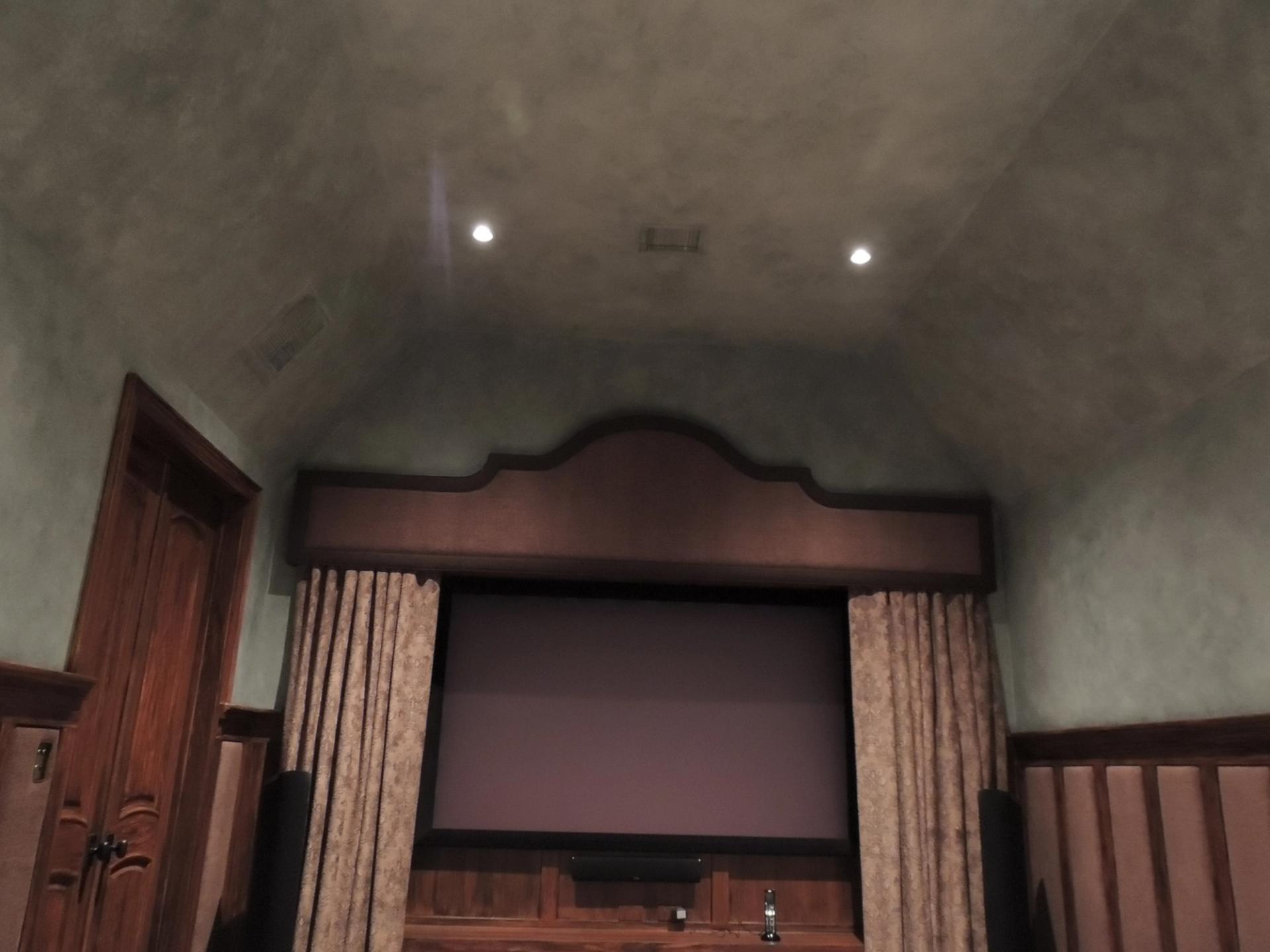 Venetian plaster barrel vault ceiling in sage grey tones inside a luxury home theater with mahogany millwork, Houston TX
