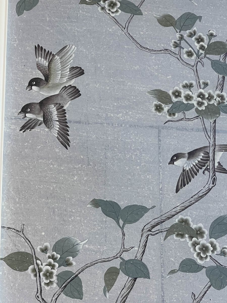 Chinoiserie hand-painted wall panel detail with sparrows in flight on silver-blue metallic ground with flowering branches.