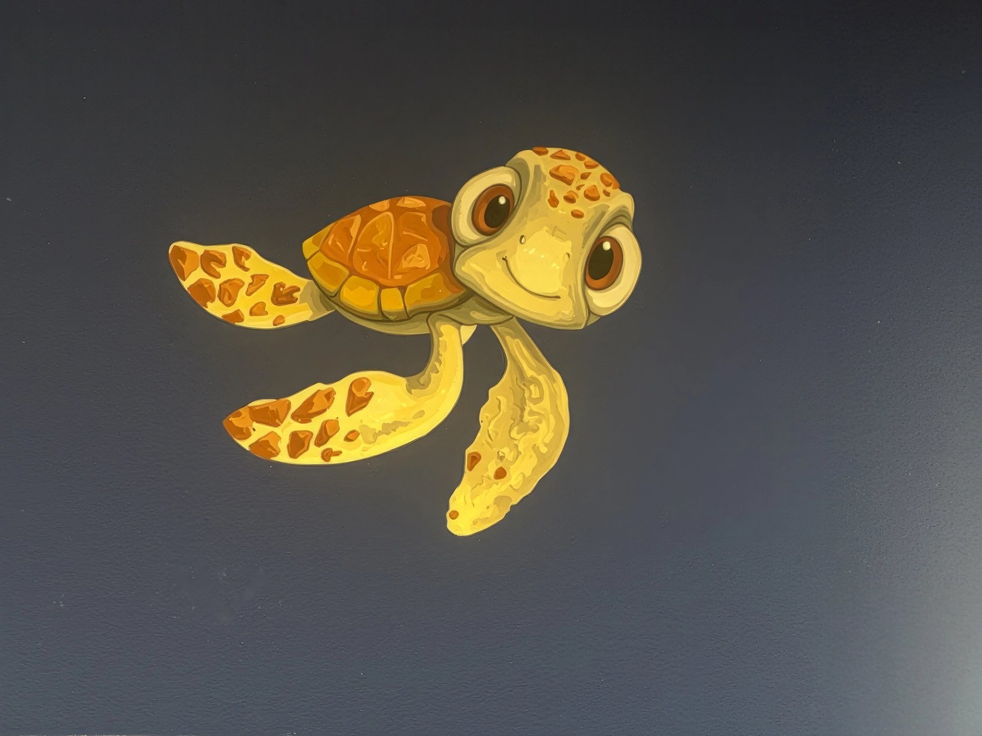 Hand-painted Finding Nemo Squirt sea turtle mural on navy wall in children's bedroom, acrylic character art