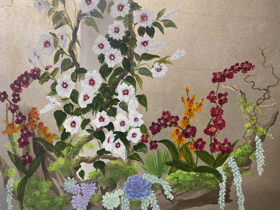 Hand-painted chinoiserie botanical mural detail with orchids, succulents, and morning glories on gold metallic wall