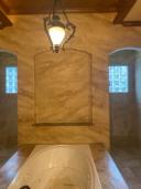 Full-envelope faux onyx master bath · arched showers · Memorial