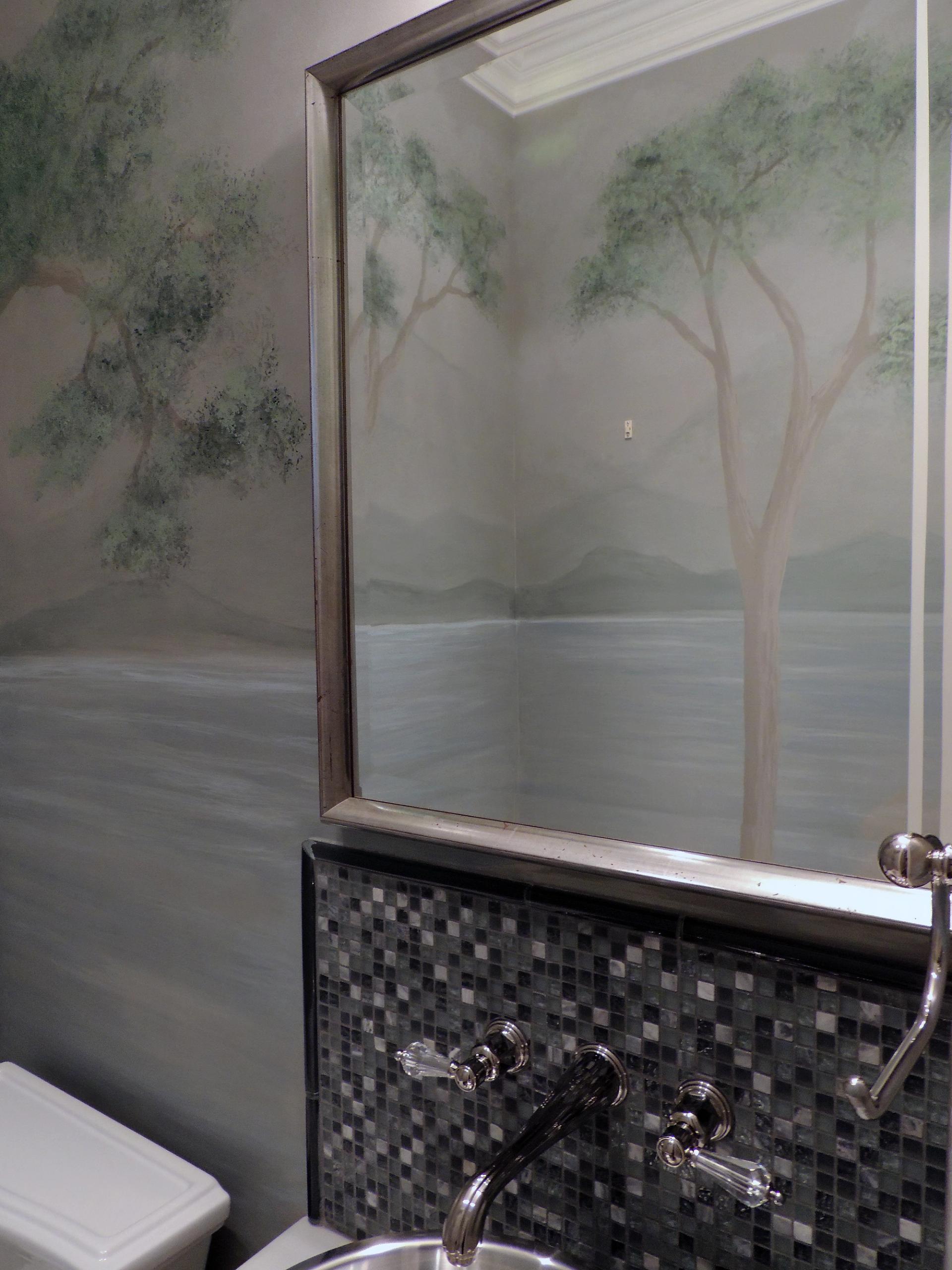 Hand-painted botanical tree mural in sage and taupe tones adorning bathroom walls alongside grey glass mosaic tile and polish