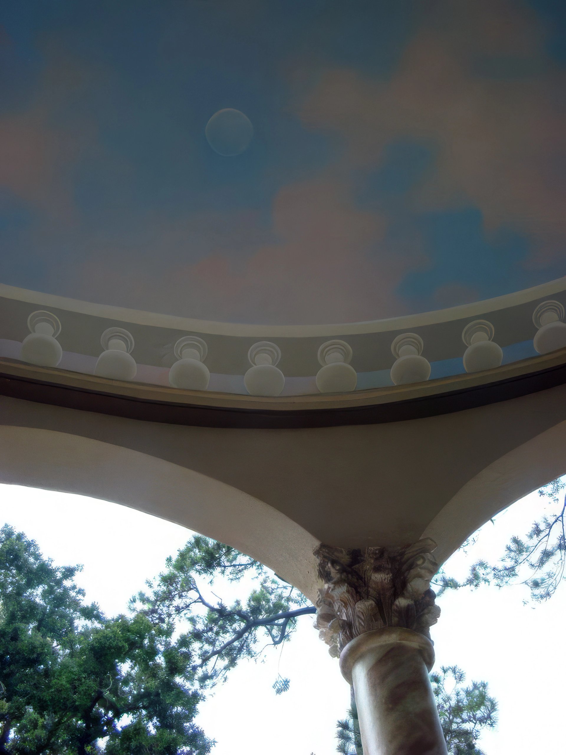 Trompe l'oeil sky mural on domed rotunda ceiling with classical dentil molding and Corinthian column, outdoor loggia