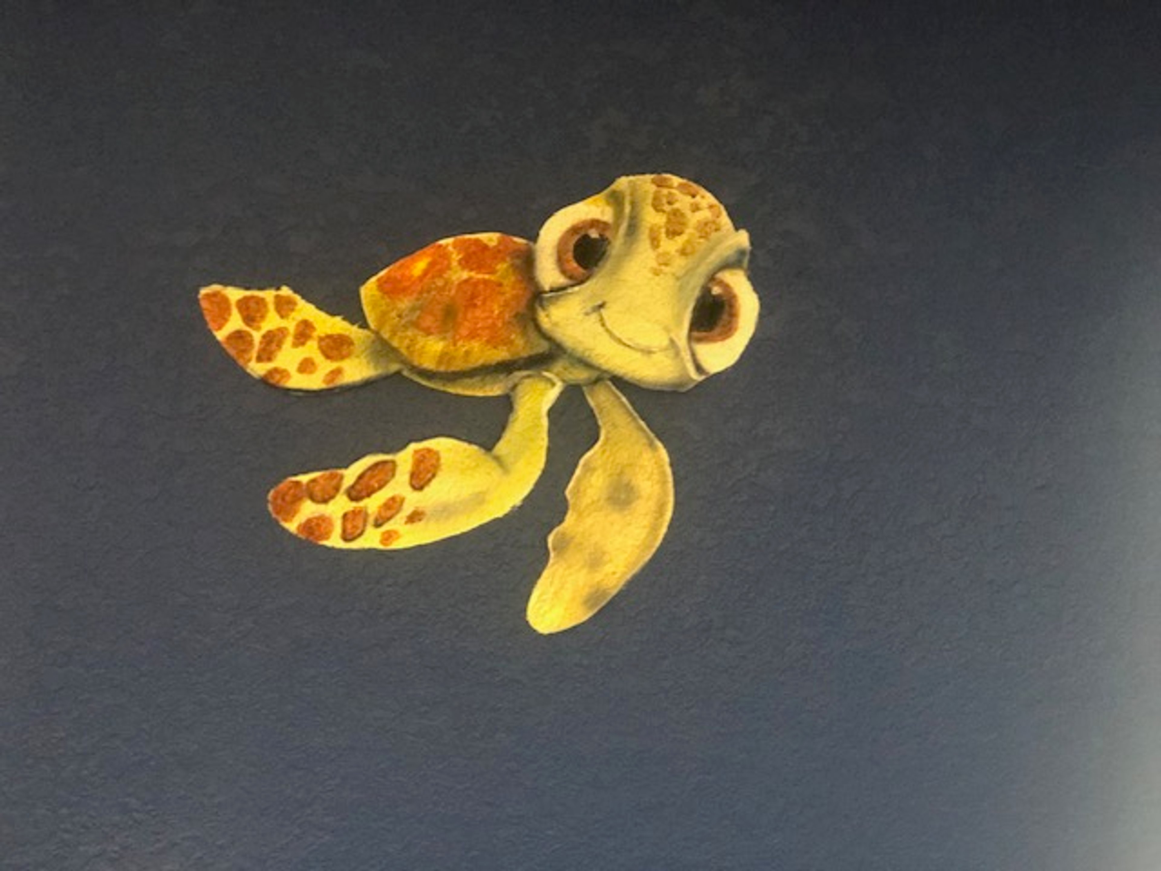 Hand-painted Finding Nemo Squirt sea turtle mural on navy wall in children's bedroom, acrylic character art