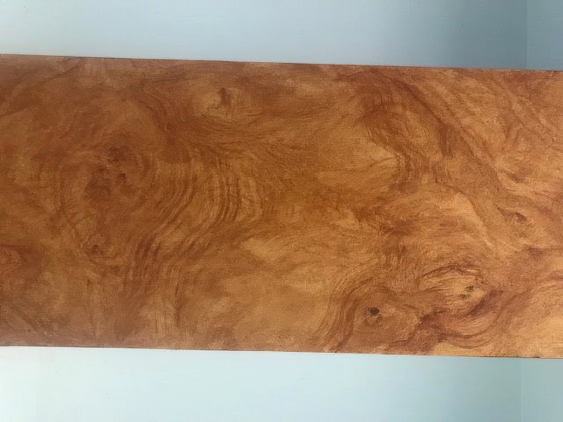 Faux burl wood finish on architectural panel, warm amber tones with hand-painted swirling grain and knot details