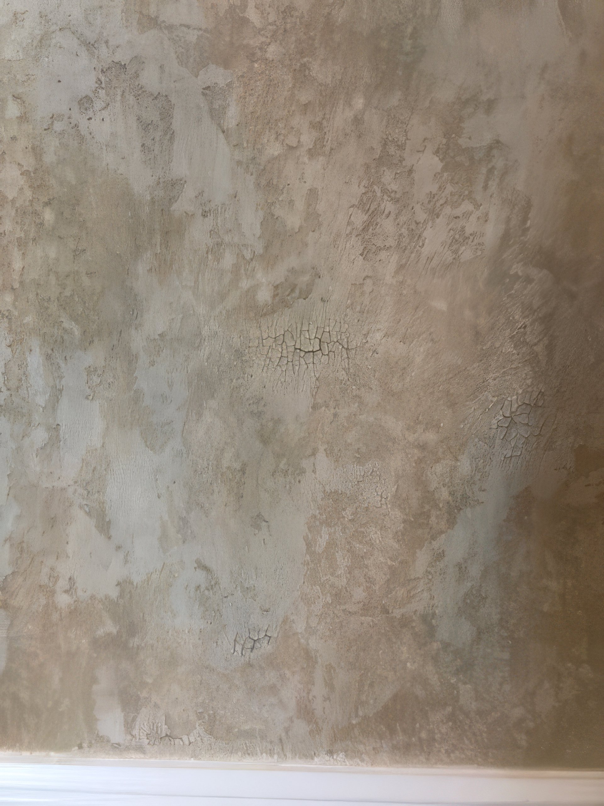 Crackle faux finish on residential wall with aged fresco effect in warm taupe and greige tones