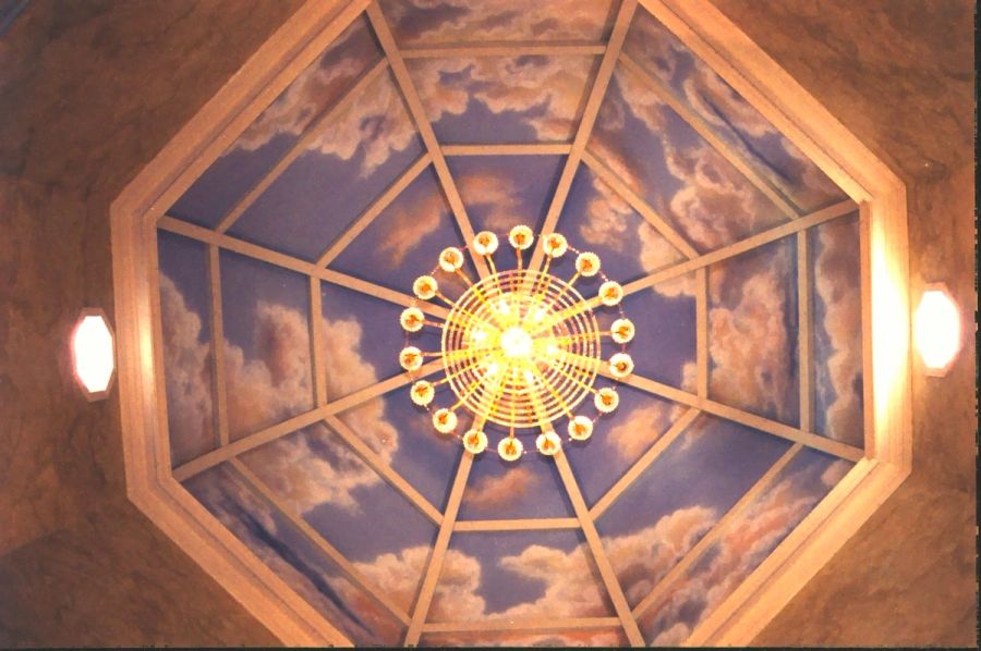 Hand-painted sky mural ceiling in octagonal coffered room with gold chandelier and twilight cloudscape, Houston.