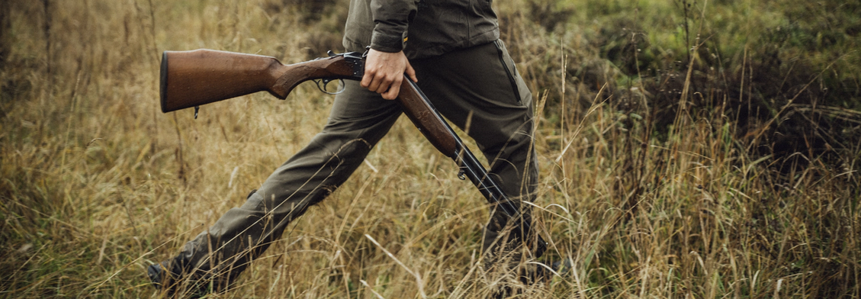 Hunter walking in grass