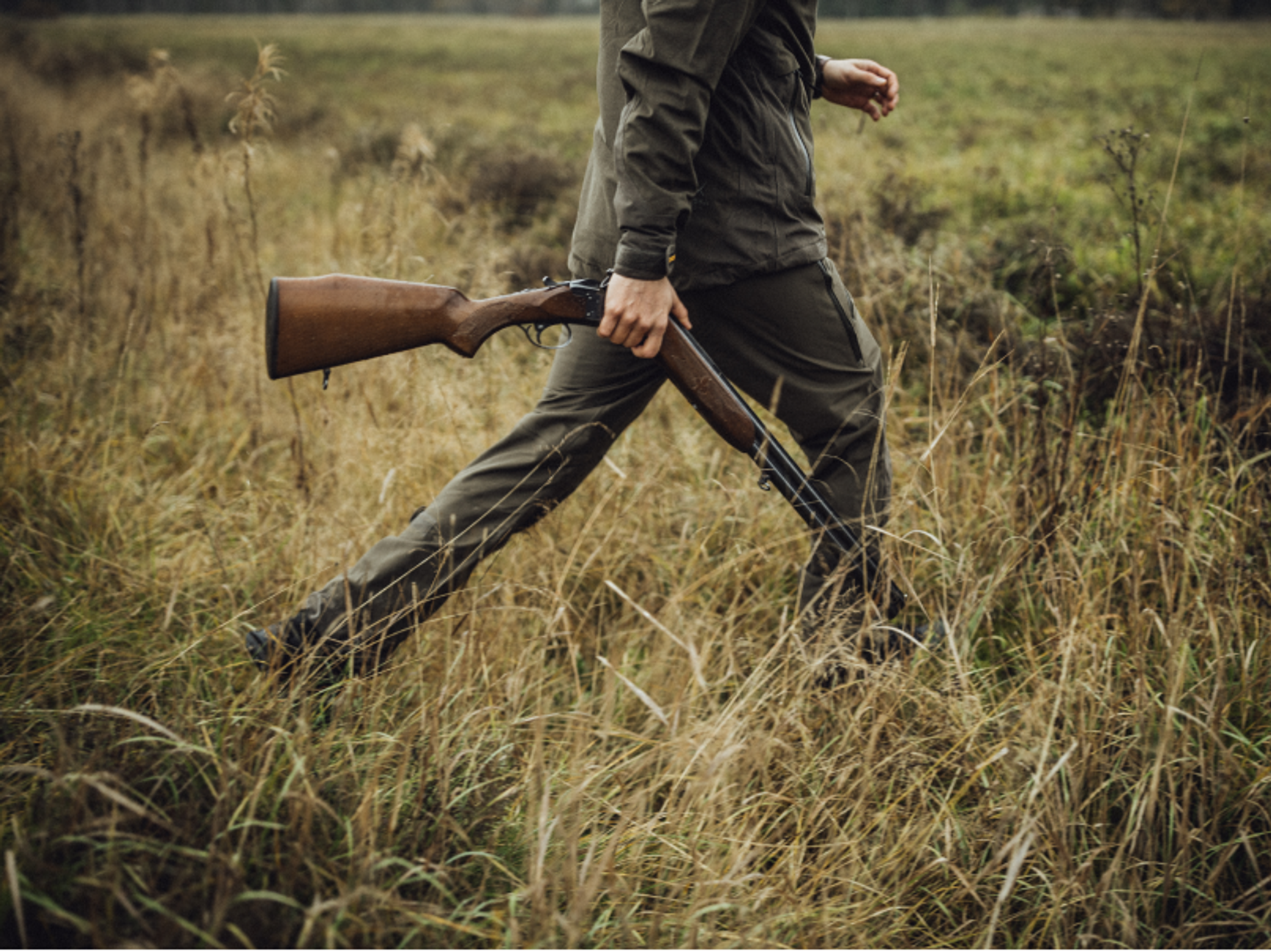 Hunter walking in grass