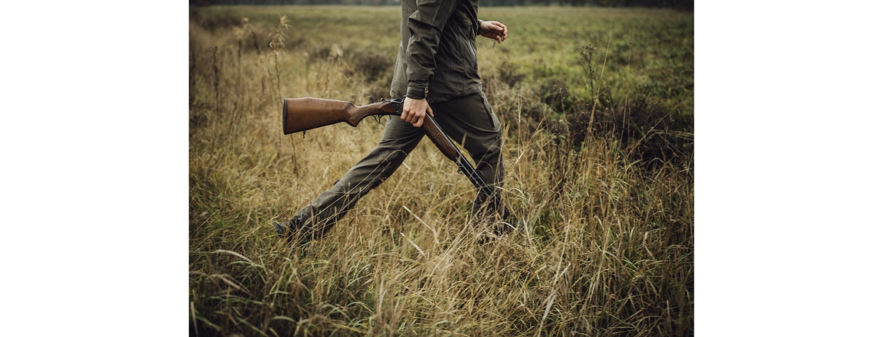Hunter walking in grass
