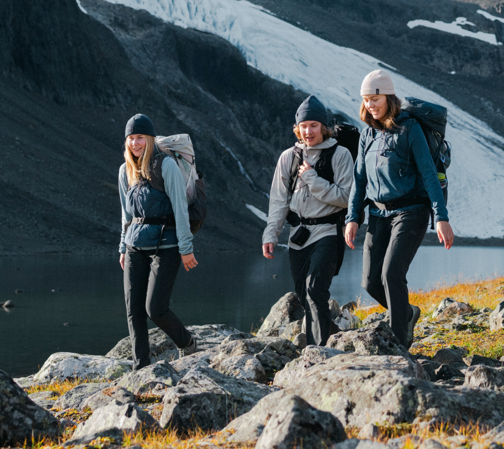 tre personer som vandrar på fjället en solig dag