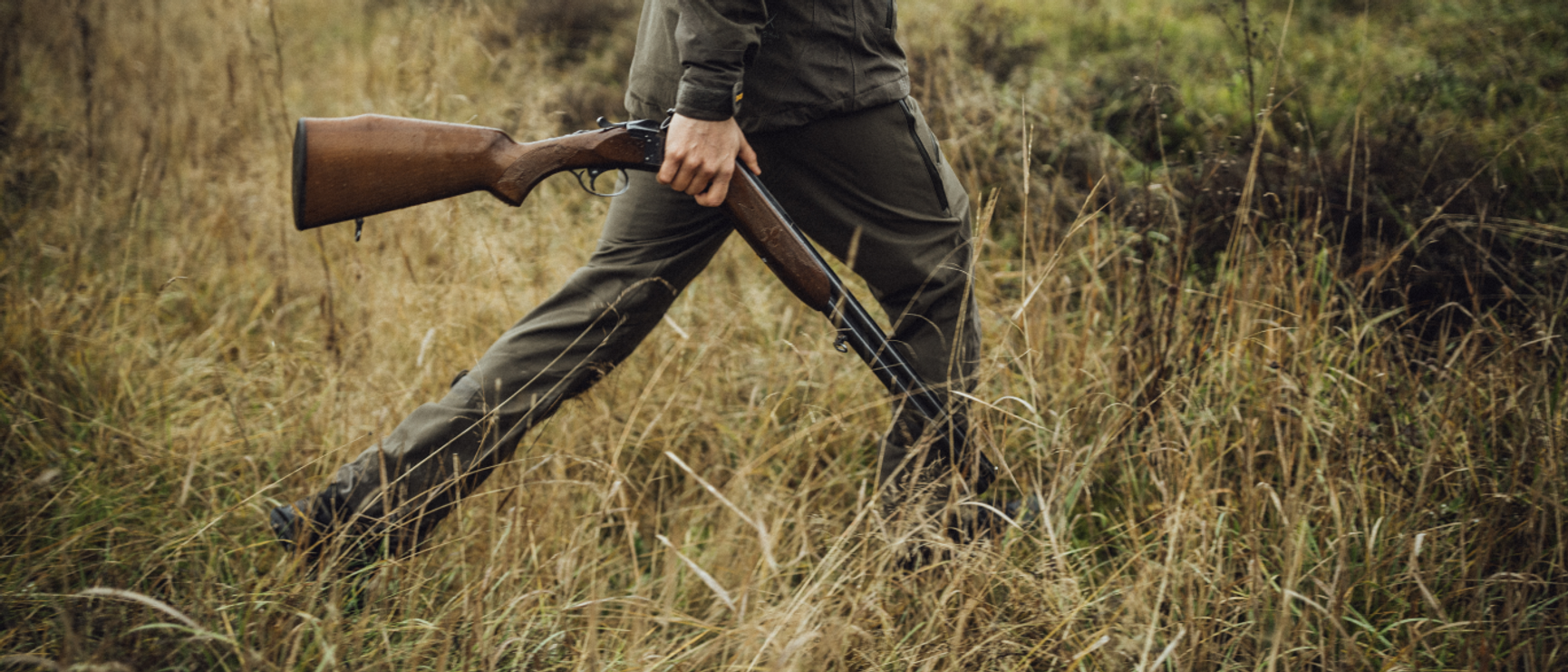 Hunter walking in grass