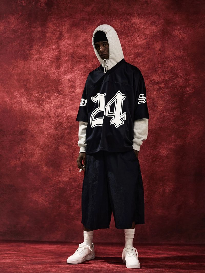 Model wearing the look: Football Jersey and Windopps Baggy Nylon Shorts