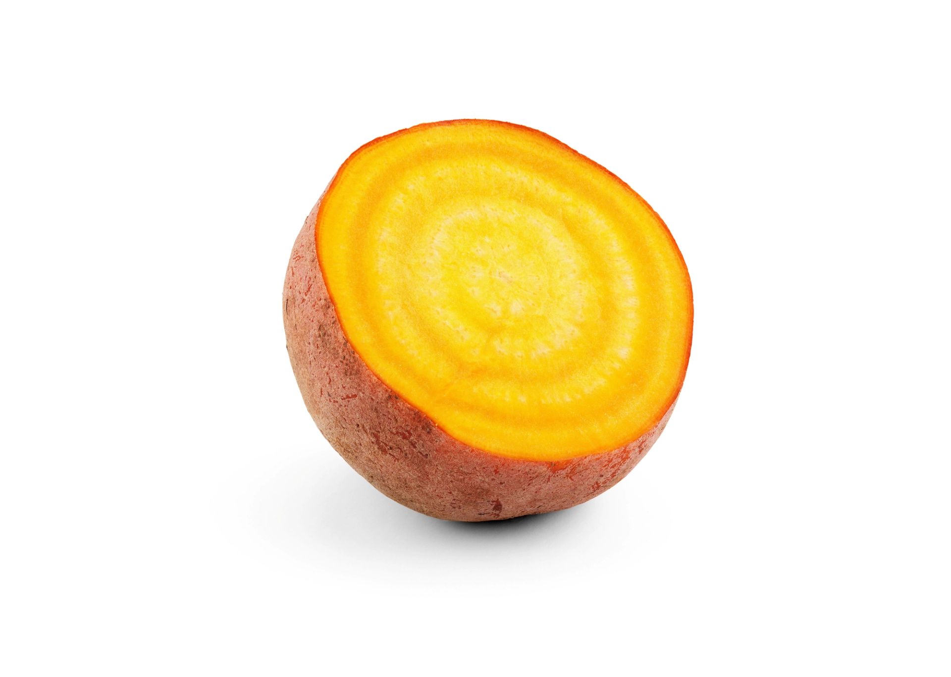 Et halvt kutt av en gulbete med konsentriske gule og oransje ringer, fotografert mot en gjennomsiktig rutete bakgrunn.