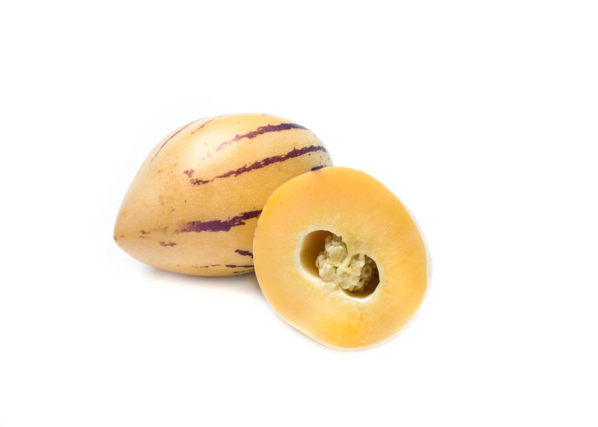 En hel pepino og en halvert pepino som viser det lysegule fruktkjøttet og den lille frøklyngen i midten, avbildet på hvit bakgrunn