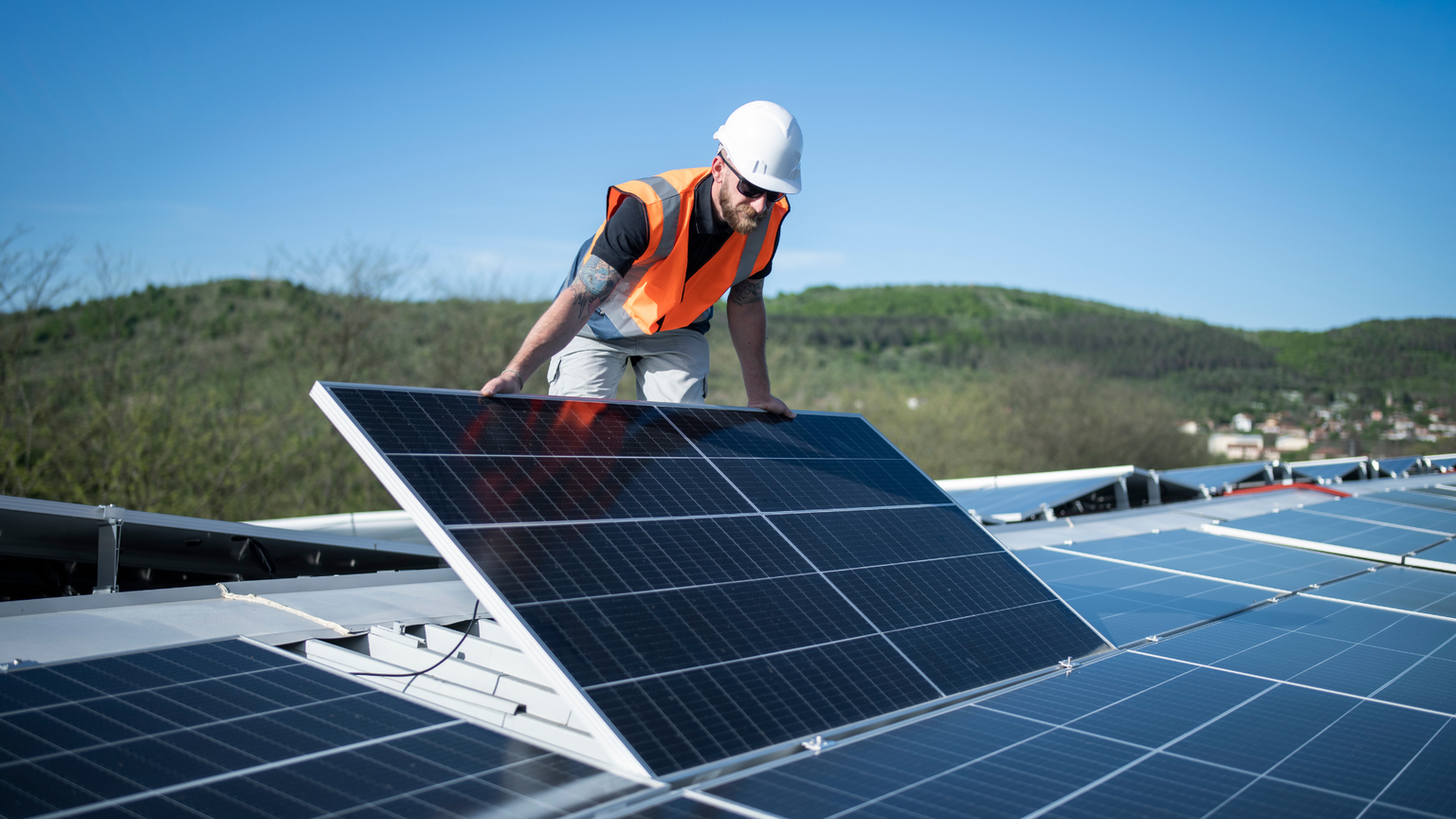 installatore su tetto che monta impianto fotovoltaico