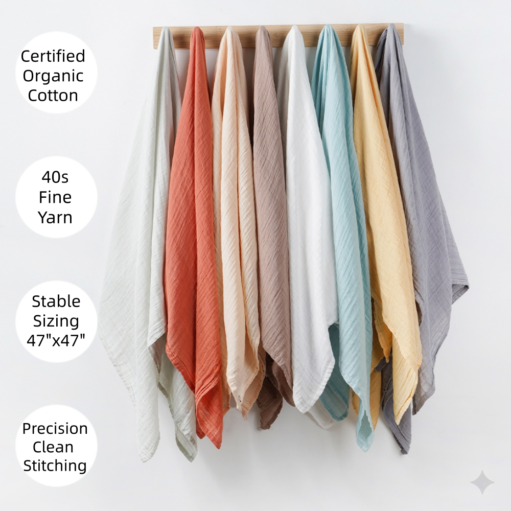 Stack of hung swaddles in grey, bric, beige,white, blue,yellow and sage