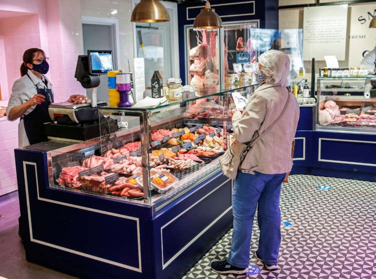 A shopper selects groceries inside a British supermarket - Global Banking & Finance Review