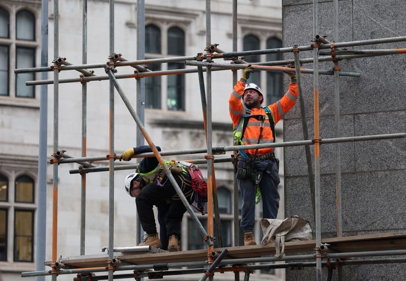 UK construction site with builders and machinery, reflecting January's declining activity - Global Banking & Finance Review