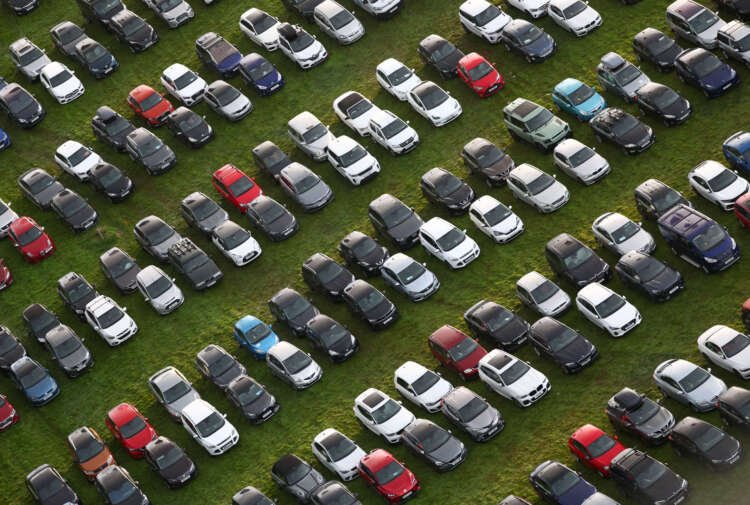 Aerial view of cars parked in Bristol, representing UK car production growth - Global Banking & Finance Review