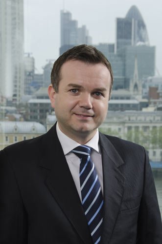 Boxes of paper documents in a dark basement, highlighting risks of physical storage - Global Banking & Finance Review