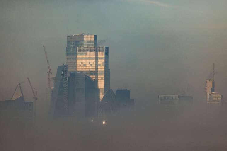 Canary Wharf financial district shrouded in fog, symbolizing banking resilience - Global Banking & Finance Review