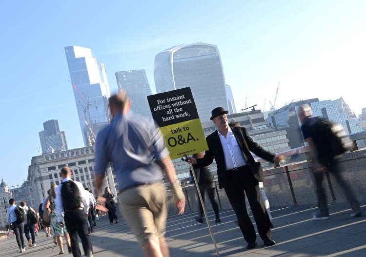 Workers crossing London Bridge during rush hour, reflecting UK long-term sickness rates - Global Banking & Finance Review