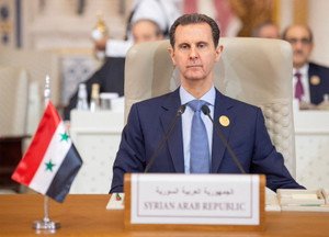 Image of Bashar al-Assad with a background of the French flag - France issues arrest warrant - Global Banking & Finance Review
