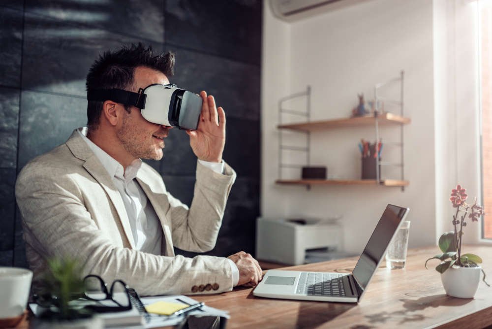 Businessman wearing a virtual reality headset for employee retraining during the COVID-19 pandemic - Global Banking & Finance Review