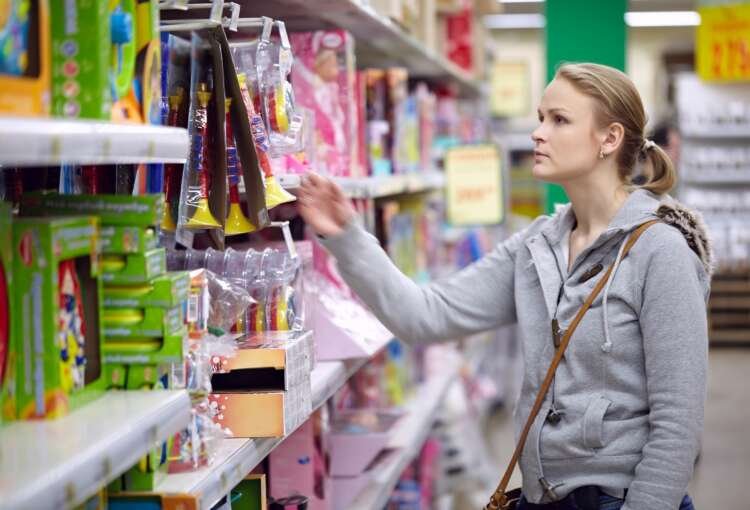 Young woman selecting sustainable toys for her child, highlighting ESG trends - Global Banking & Finance Review