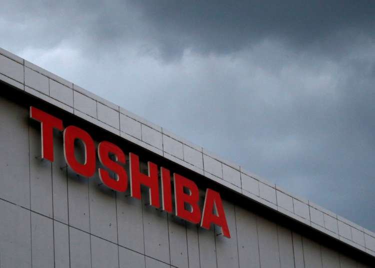Toshiba's headquarters with financial graphs highlighting shareholder interests - Global Banking & Finance Review