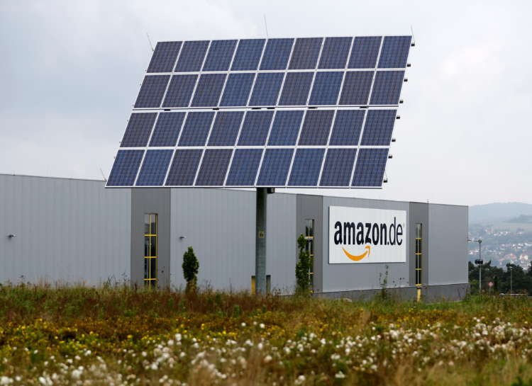 Amazon logo with a backdrop representing sustainable finance initiatives - Global Banking & Finance Review