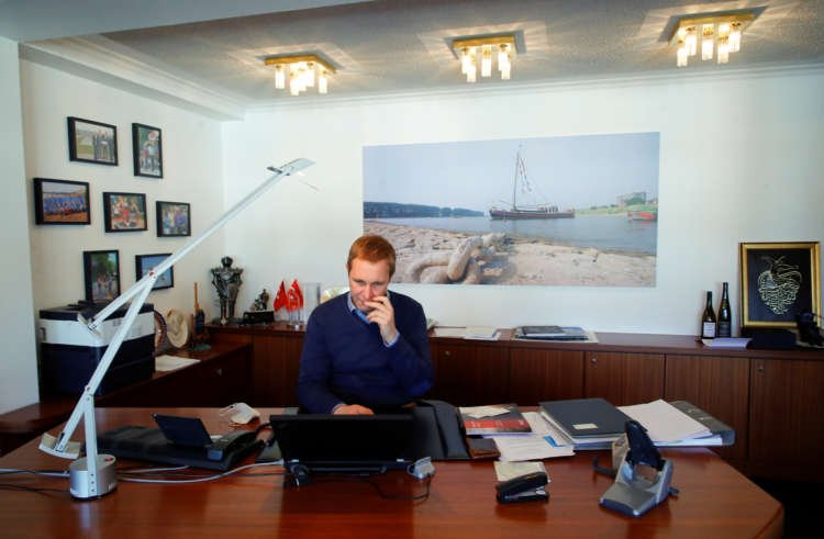 Mayor Daniel Zimmermann works at the townhall of the North-Rhine Westphalian town of Monheim am Rhein, Germany