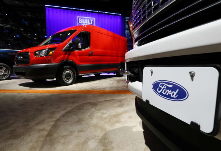 Ford trucks displayed at an auto show, highlighting production cuts amid global chip shortage - Global Banking & Finance Review