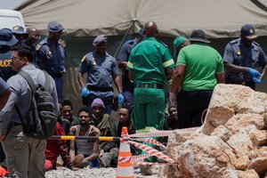 South African police lowering a cage into mine to check for survivors after 78 deaths - Global Banking & Finance Review