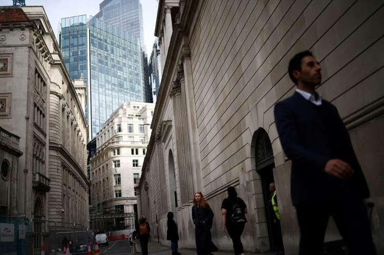 People exit the Bank of England, reflecting UK financial resilience amidst stress tests - Global Banking & Finance Review