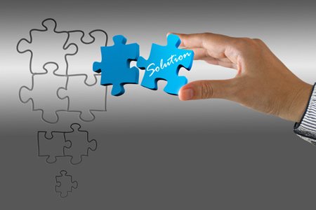 A collection of hand puzzles symbolizing financial decision making - Global Banking & Finance Review