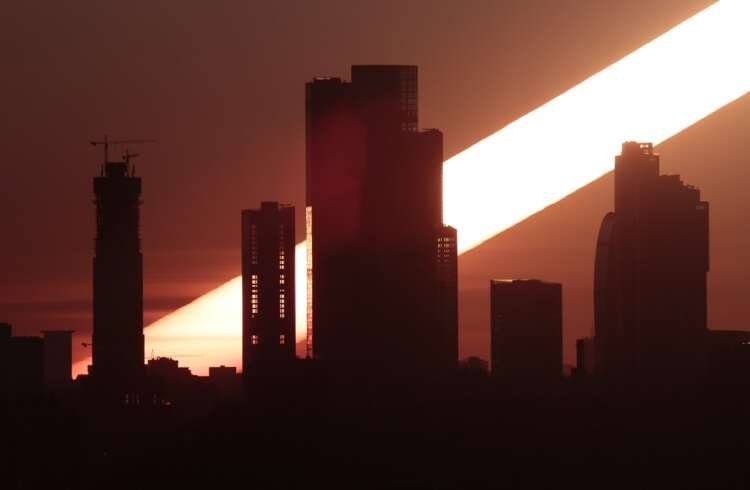 The sun rises behind the skyscrapers of the Moscow International Business Centre in Moscow